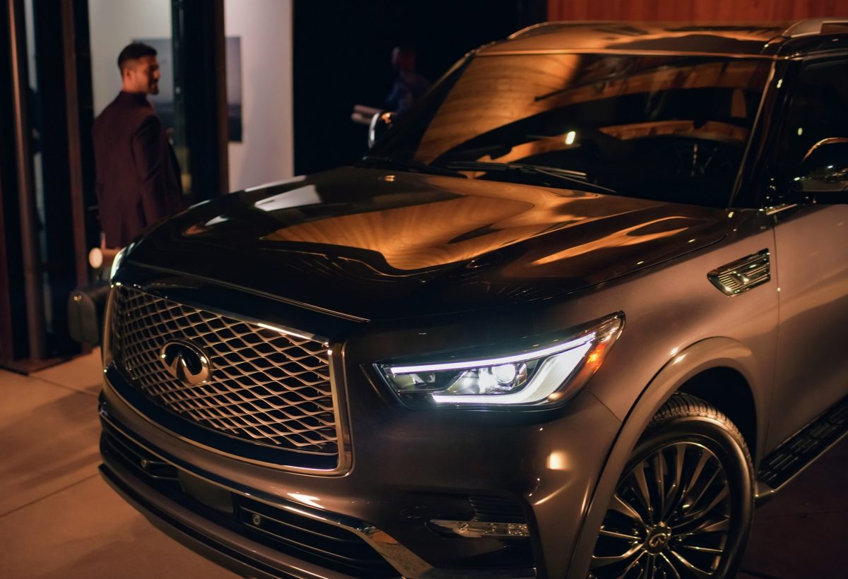 Angled 2024 INFINITI QX80 7-8 passenger SUV in dark grey