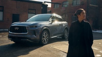 INFINITI Maker standing next to All-New QX80