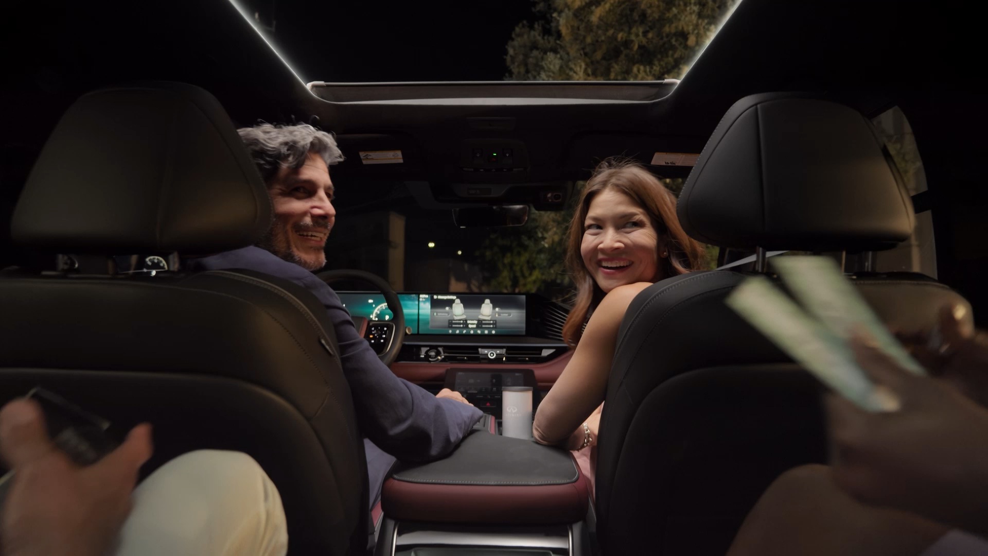 Driver and passenger in the front seats of an INFINITI SUV