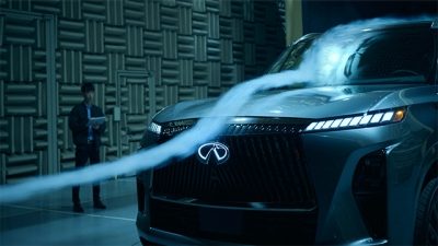 INFINITI Maker standing next to All-New QX80
