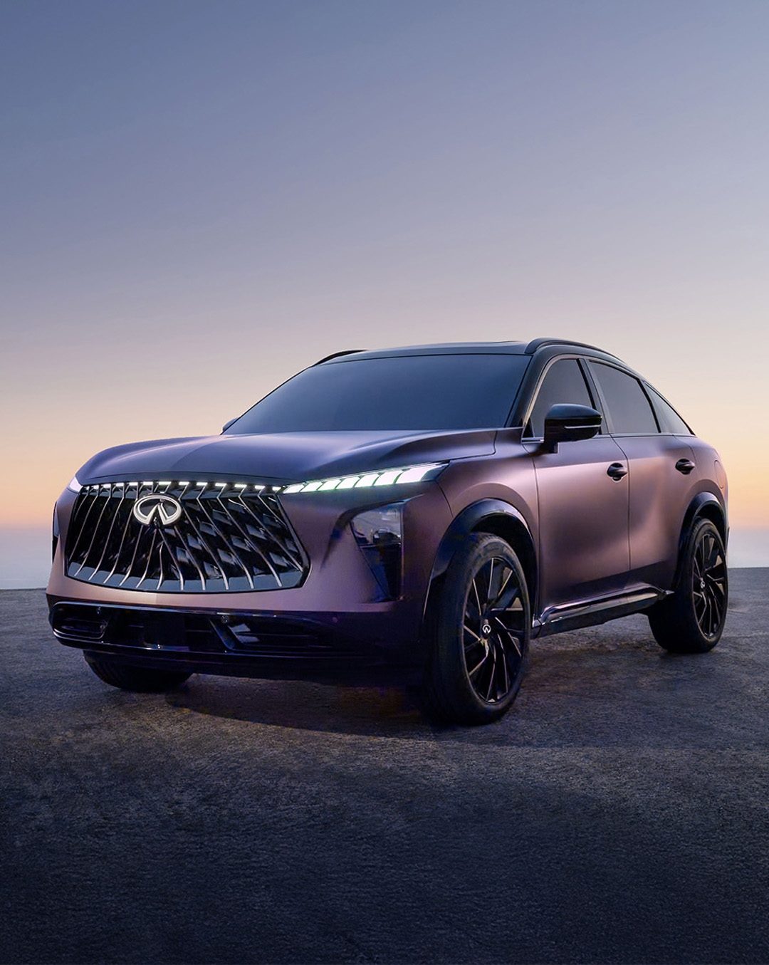 Front half of INFINITI QX65 monograph under burgundy lighting