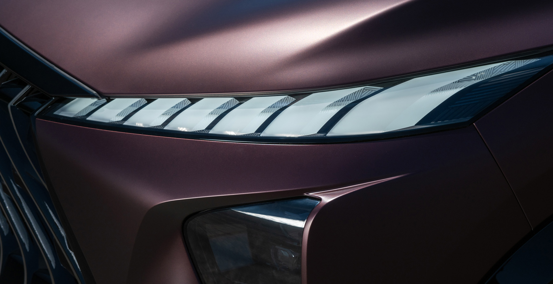 Driver-side front corner of the QX65 highlighting headlights and mirror