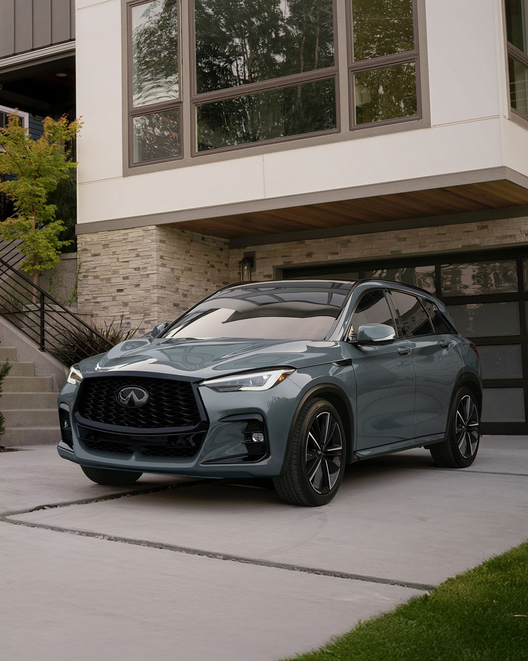 An INFINITI QX50 compact luxury SUV in urban residential setting