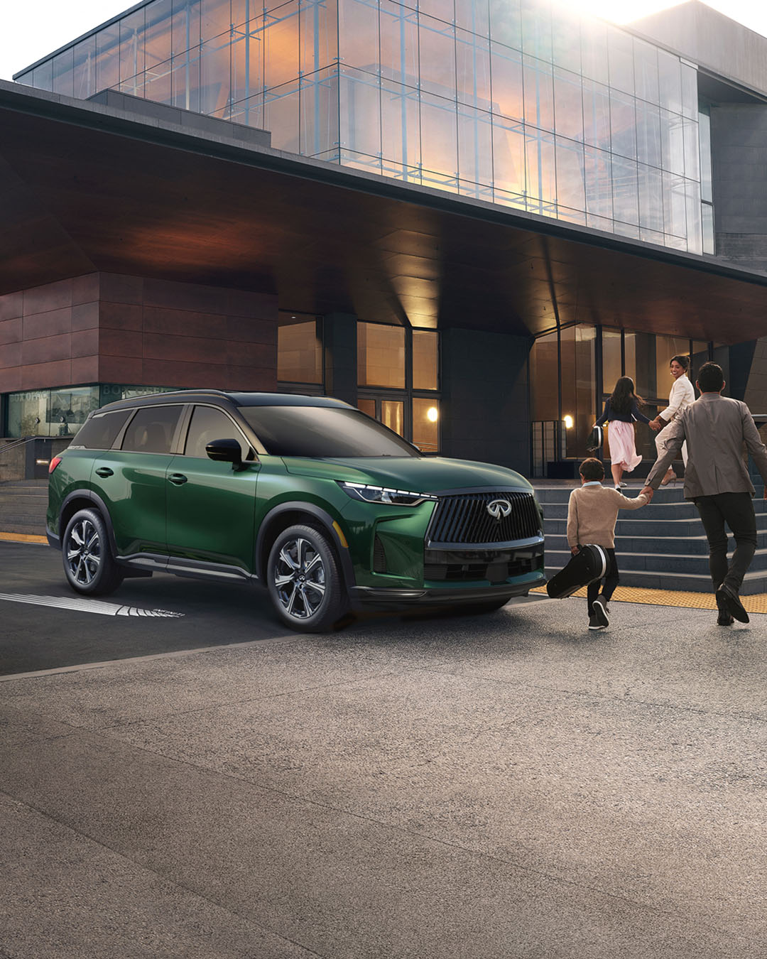 Family walking past the INFINITI QX60 SUV parked in front of house