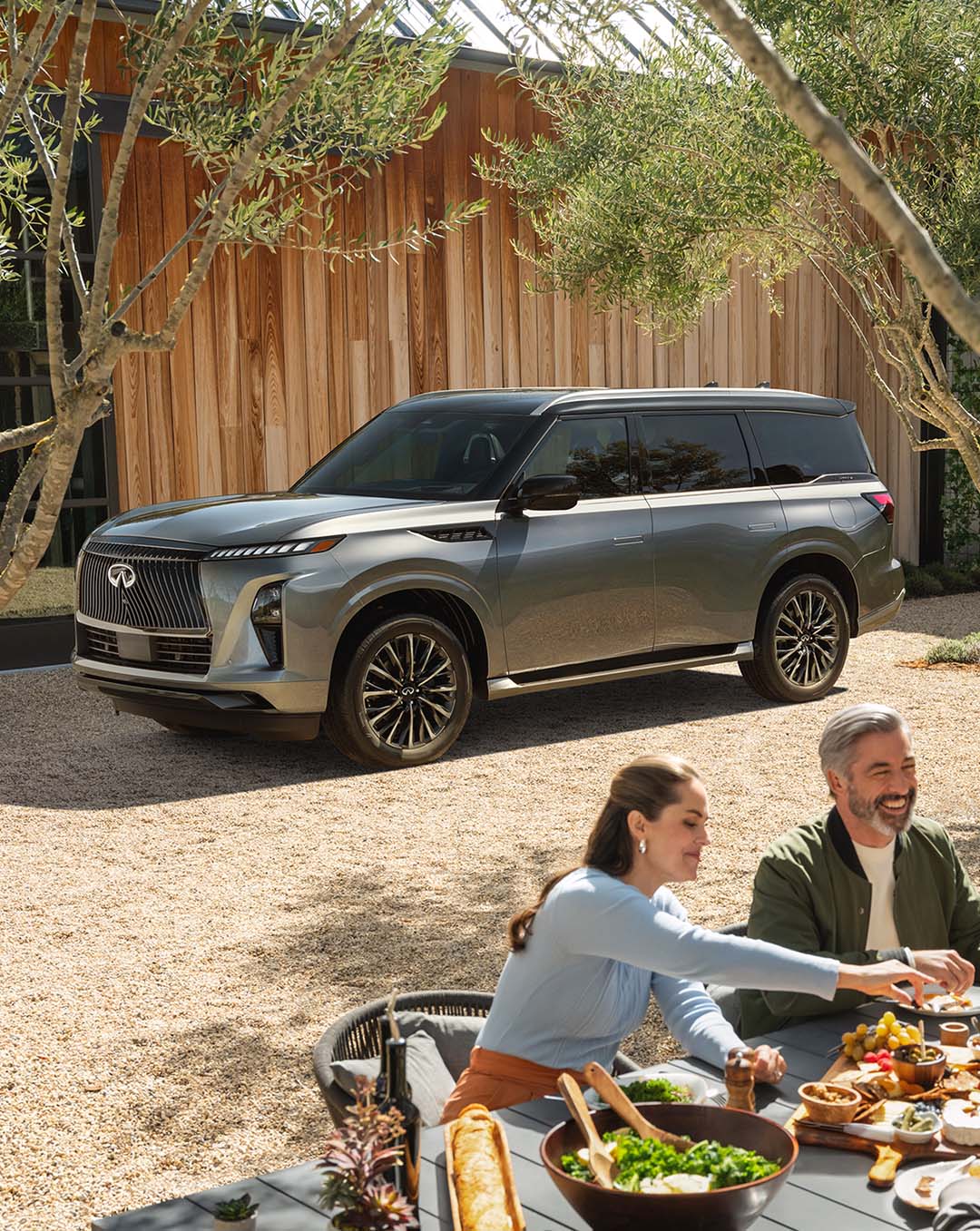QX80 parked in front of modern home