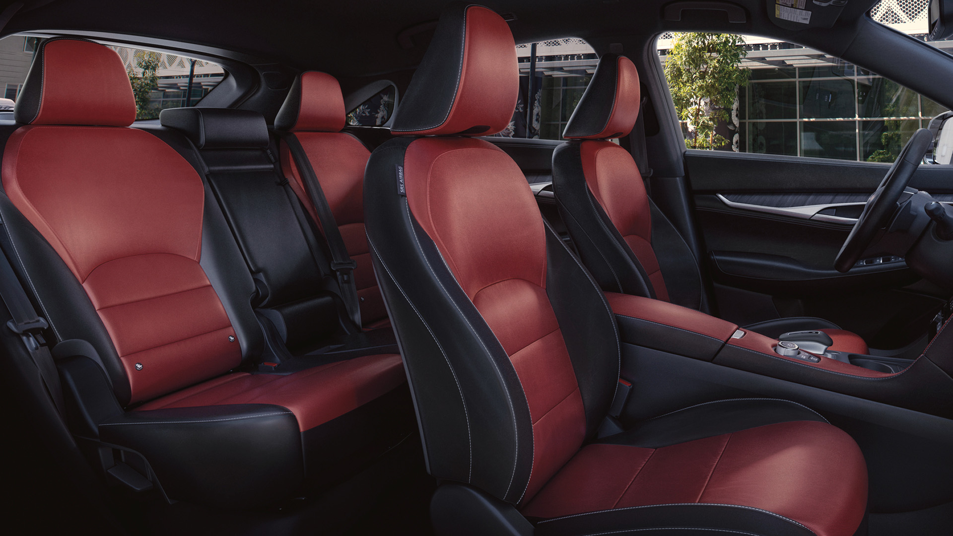 Interior view showing red leather seats with space for five passengers in the QX55