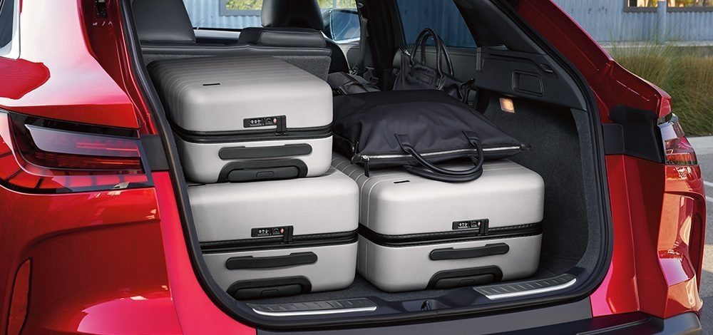 QX55 cargo space packed with four travel suitcases