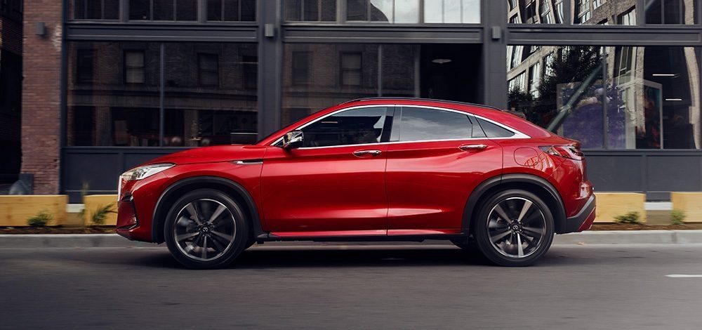 Side profile view of 2025 INFINITI QX55 on city street