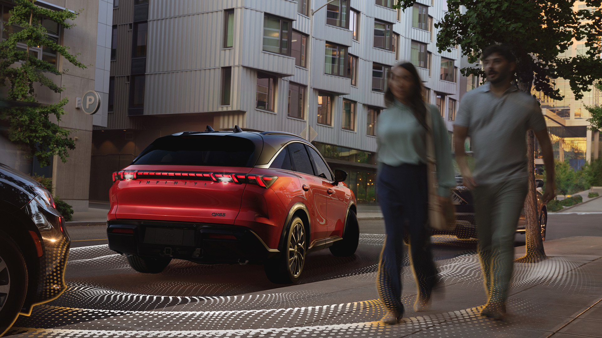 Red INFINITI QX65 demonstrating Rear Cross Traffic Alert and Rear Automatic Braking technology