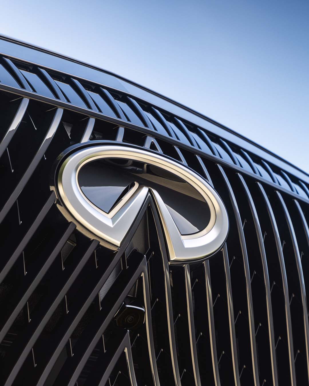Close-up of INFINITI grille and emblem representing brand identity