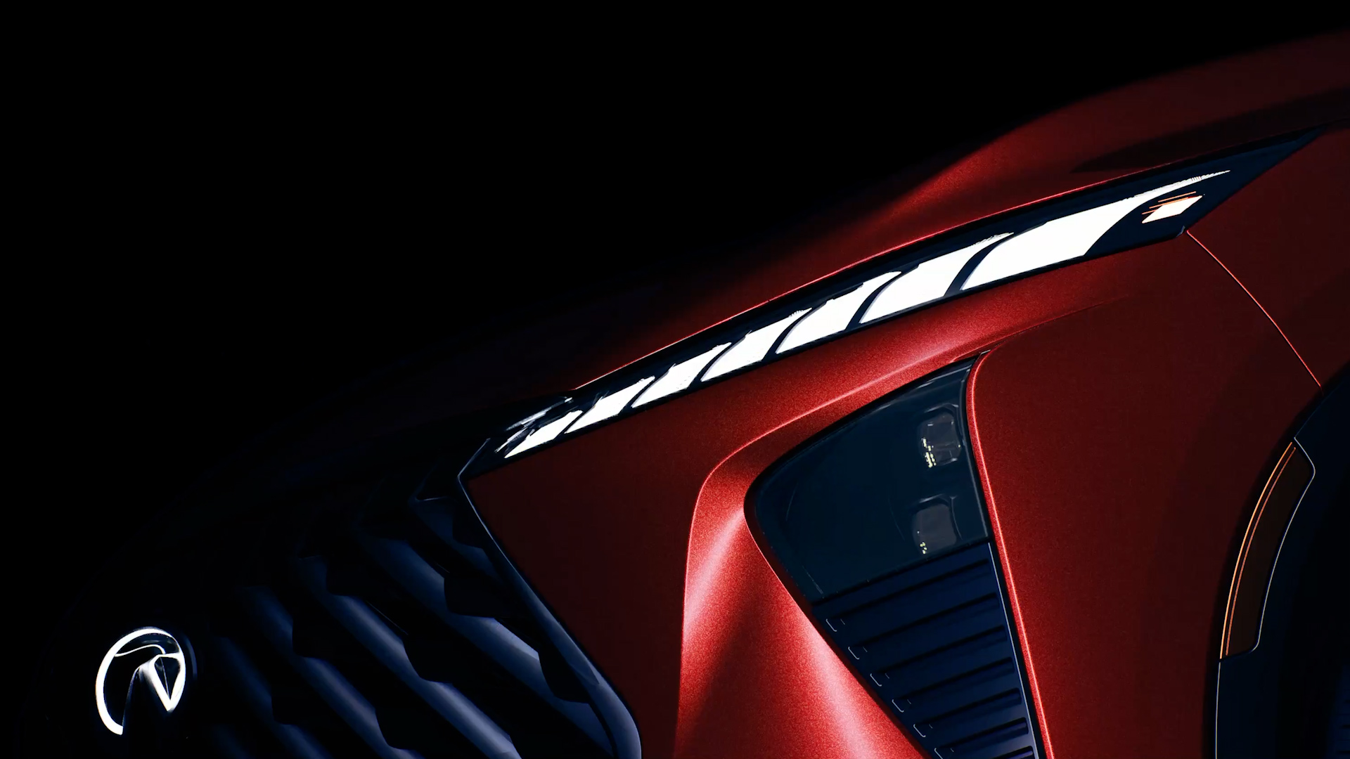 Close-up of INFINITI QX65 front LED lighting and sculpted grille design