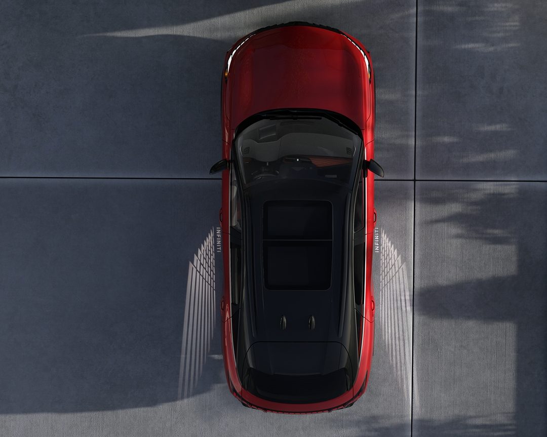 INFINITI QX65 projecting illuminated light path onto the ground at night