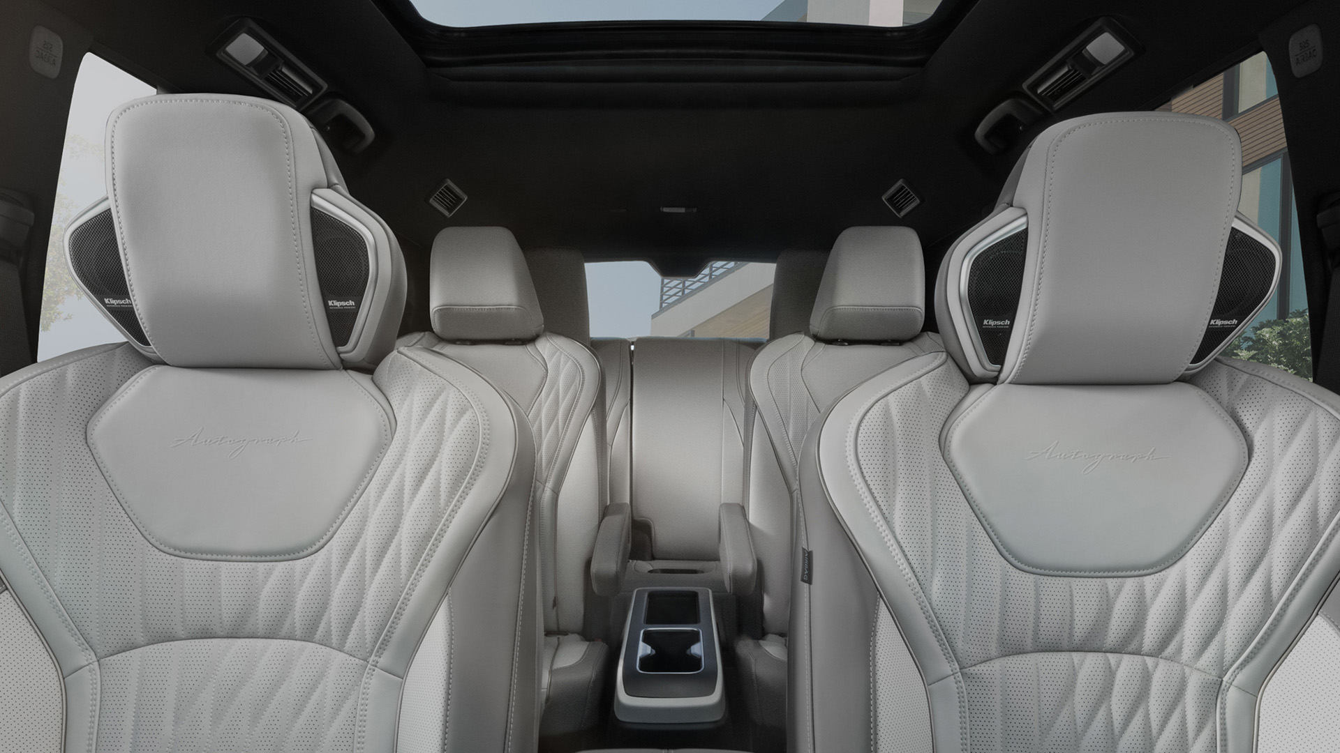 Full interior view showing three rows of quilted seats, configured for up to 7 passengers