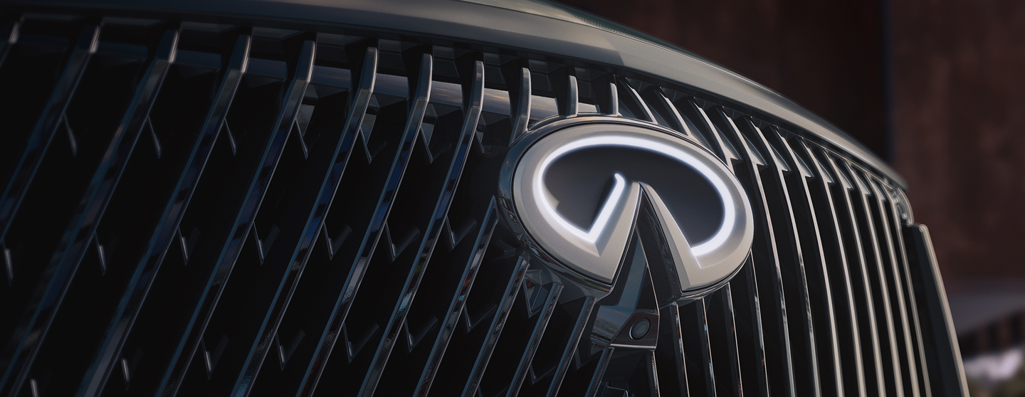 Close-up of the INFINITI QX60 front grille and illuminated emblem used in the next steps section