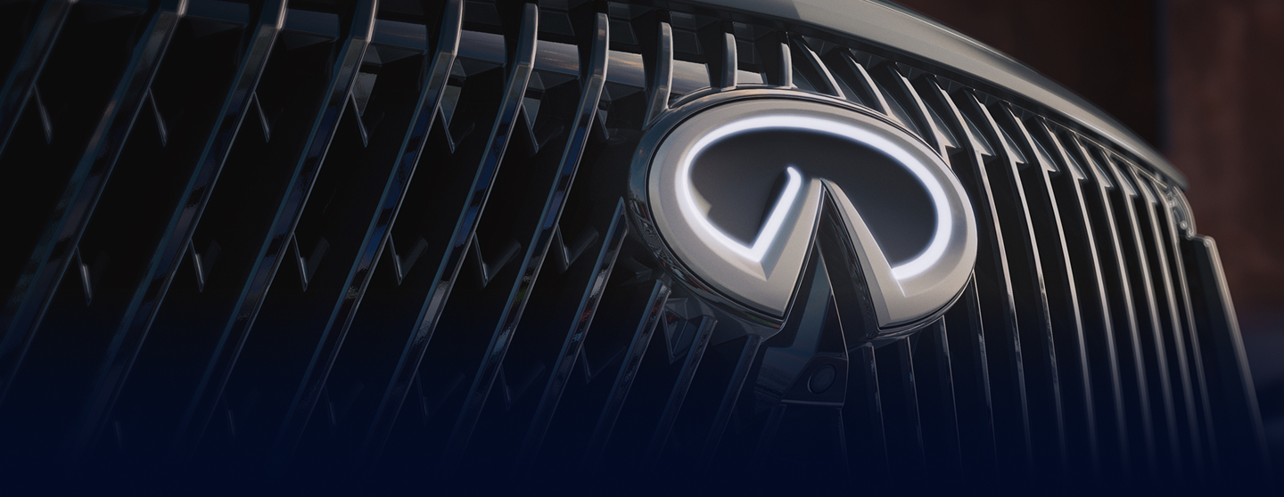 Close-up of the INFINITI QX60 front grille and illuminated emblem used in the next steps section