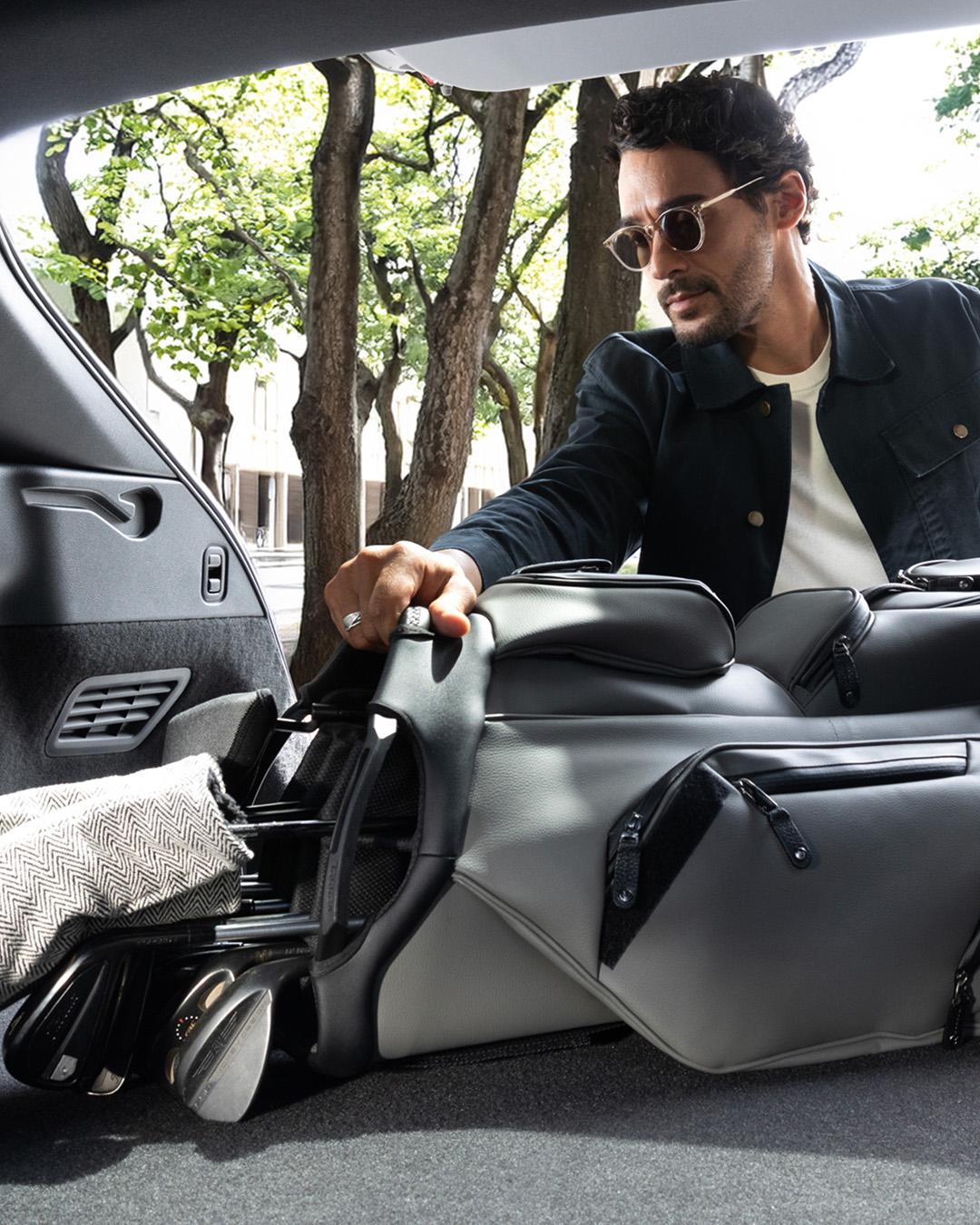 INFINITI QX65 cargo area loaded with luggage demonstrating cargo capacity