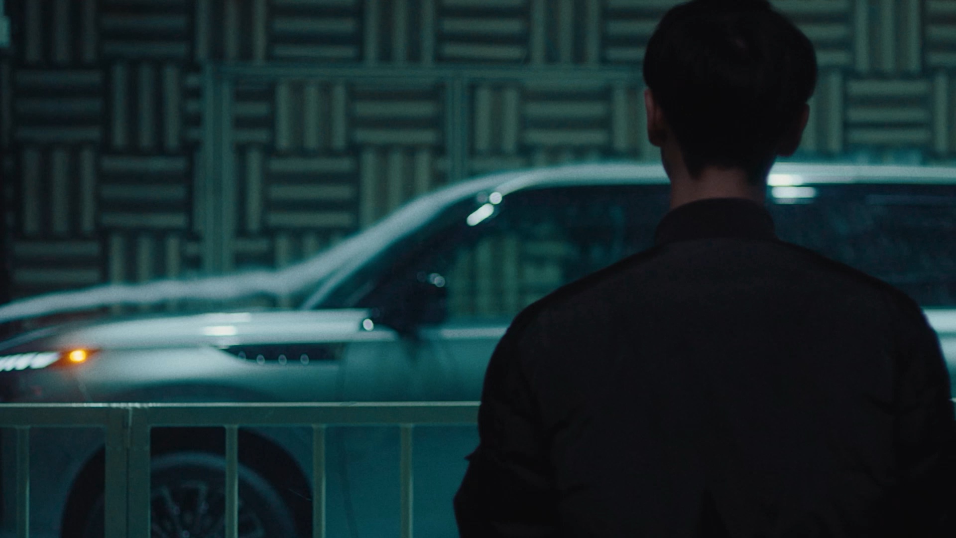 INFINITI Maker Takuma Kadotani looking at QX80 SUV