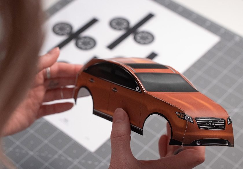 Person holding Infiniti Carigami model