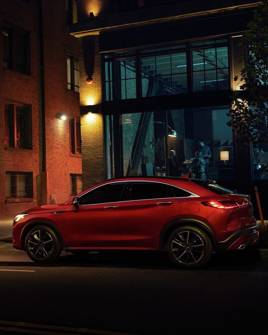 INFINITI QX55 crossover coupe parked outside building at night