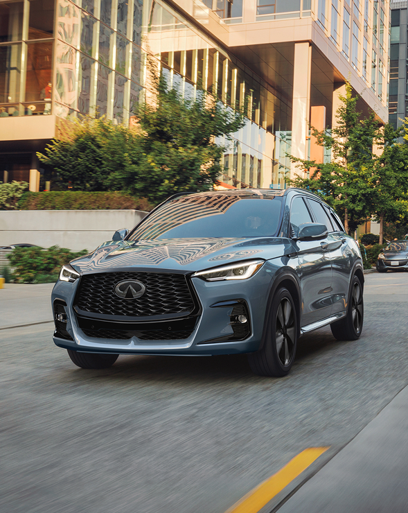 INFINITI QX50 compact SUV parked in front of building