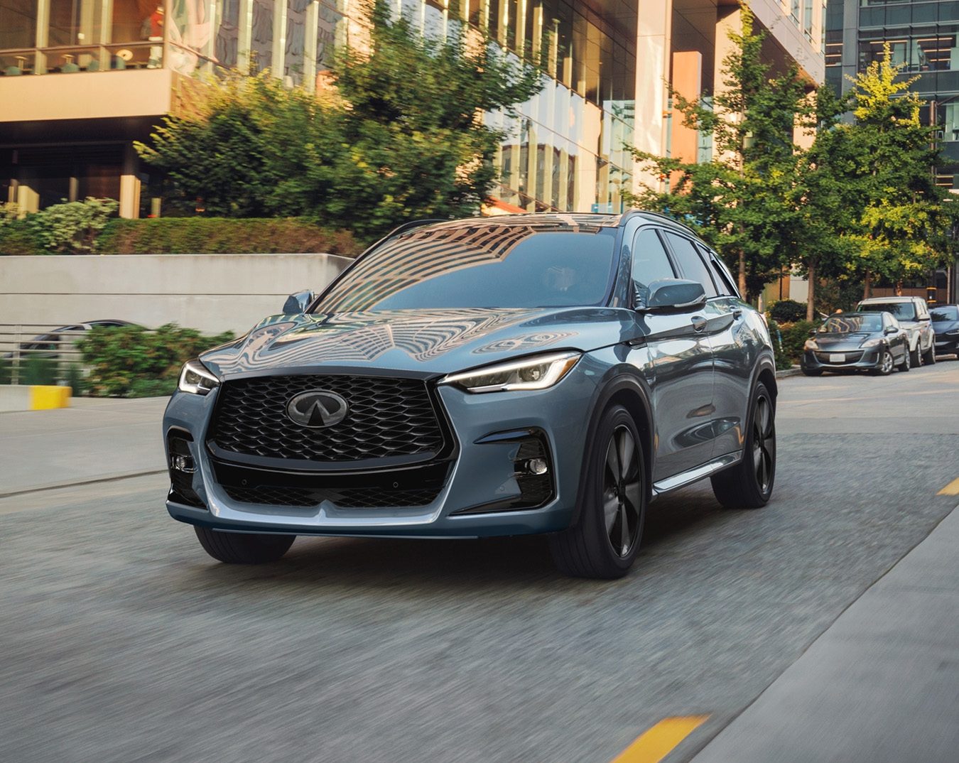 Certified pre-owned INFINITI QX50 driving through a city street