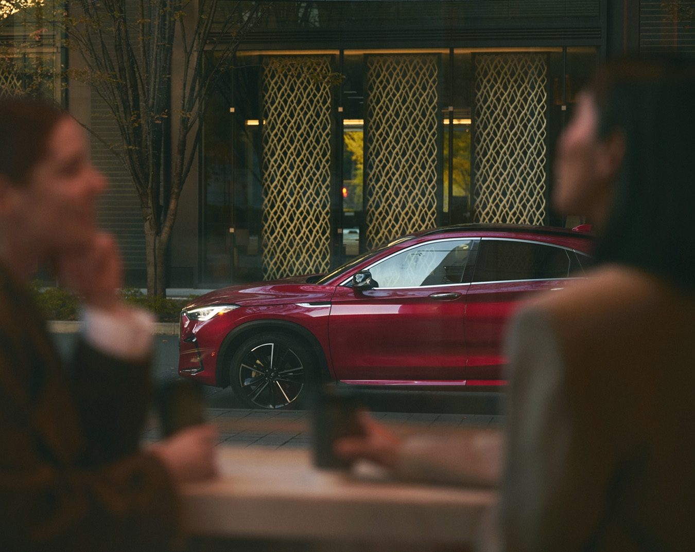 Certified pre-owned INFINITI QX55 luxury crossover parked in an urban environment