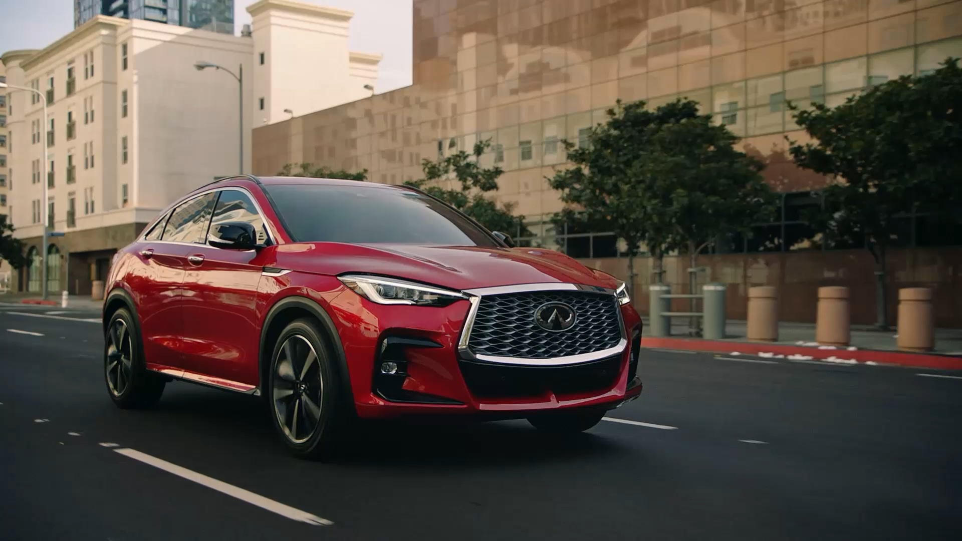 Video of red INFINITI QX55 driving along city streets