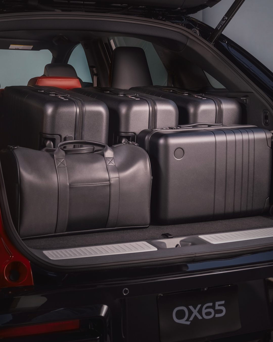 INFINITI QX65 cargo area loaded with luggage demonstrating cargo capacity