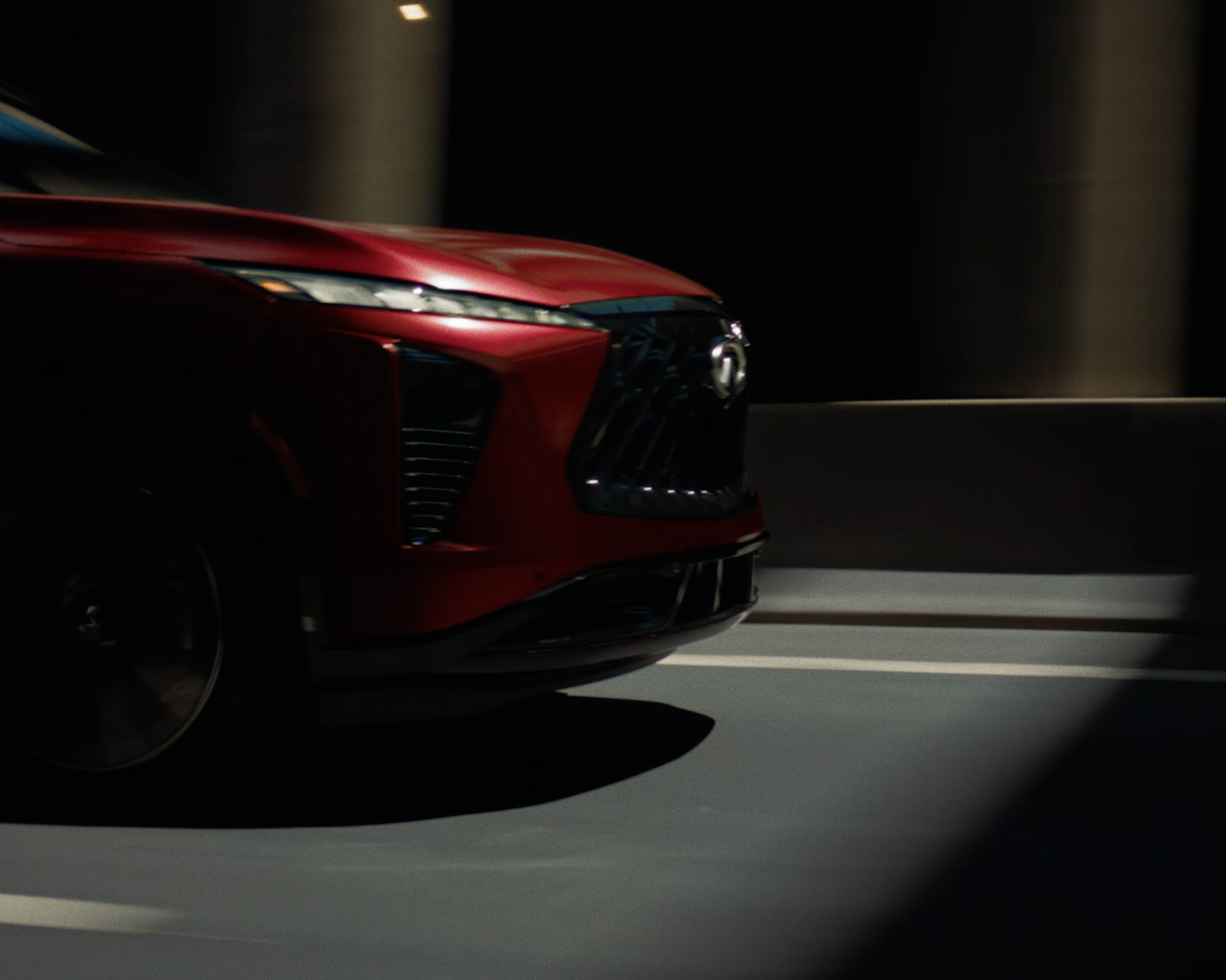 Driver experiencing the refined performance and sound enhancement features of the 2027 INFINITI QX65