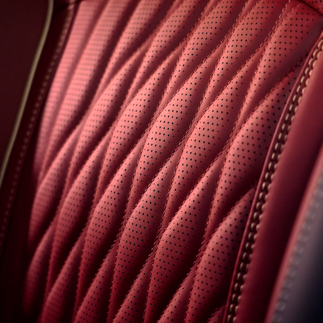 Close-up of kimono-inspired stitching and perforated leather upholstery in the 2027 INFINITI QX65
