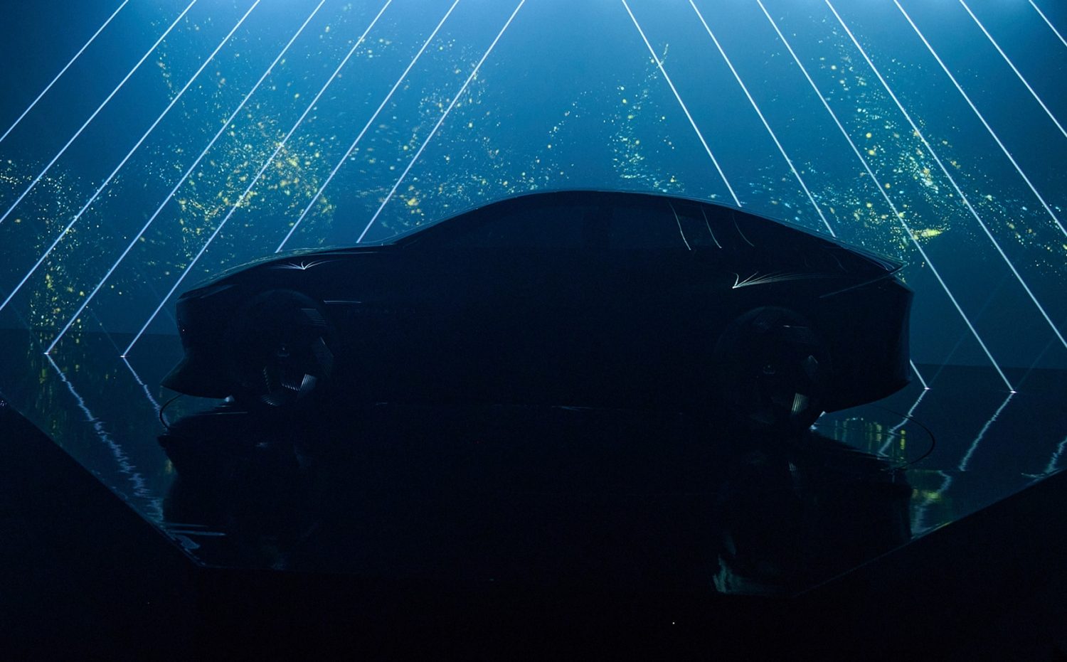 INFINITI Vision Qe electric concept vehicle displayed with futuristic lighting installation