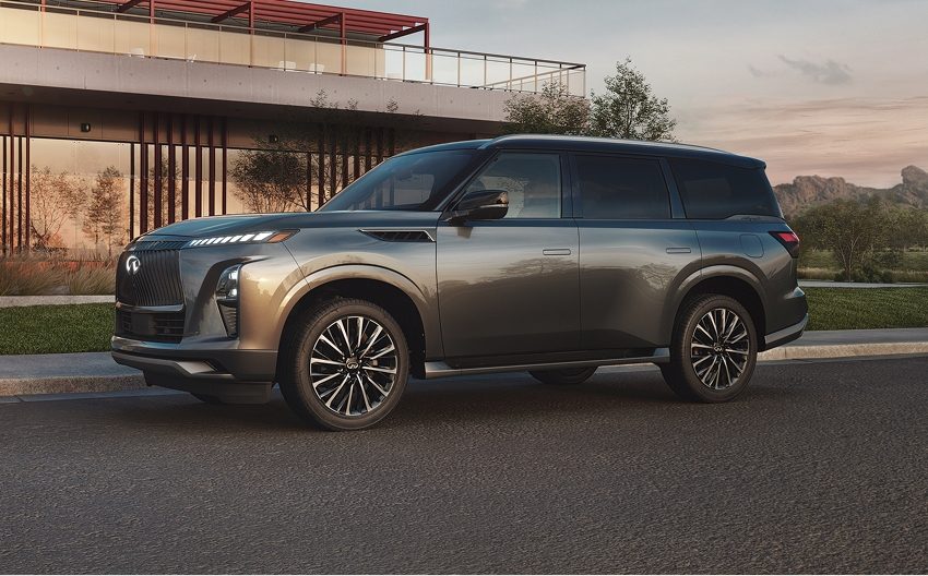 INFINITI QX80 luxury SUV parked on street in front of modern building