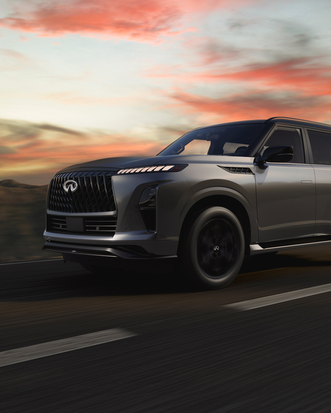 2027 INFINITI QX80 driving through sunset showcasing ProPilot assist features. 